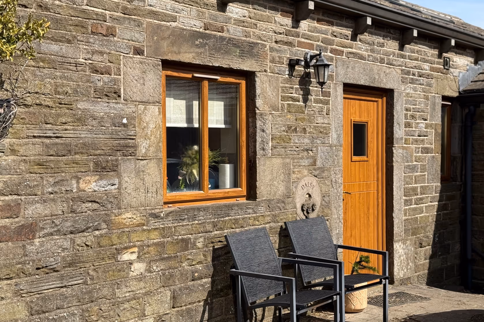 An outside view of Daisy cottage at Lazy Daisy's