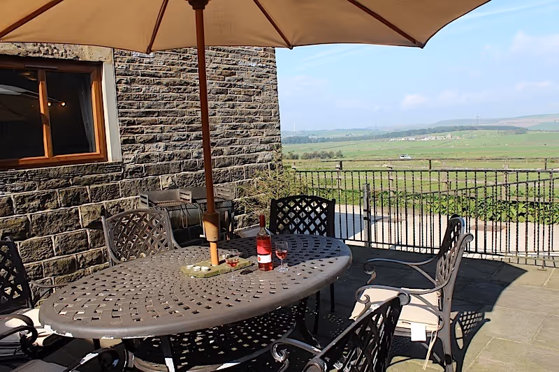 An outside view of Moon Penny cottage at Lazy Daisy's